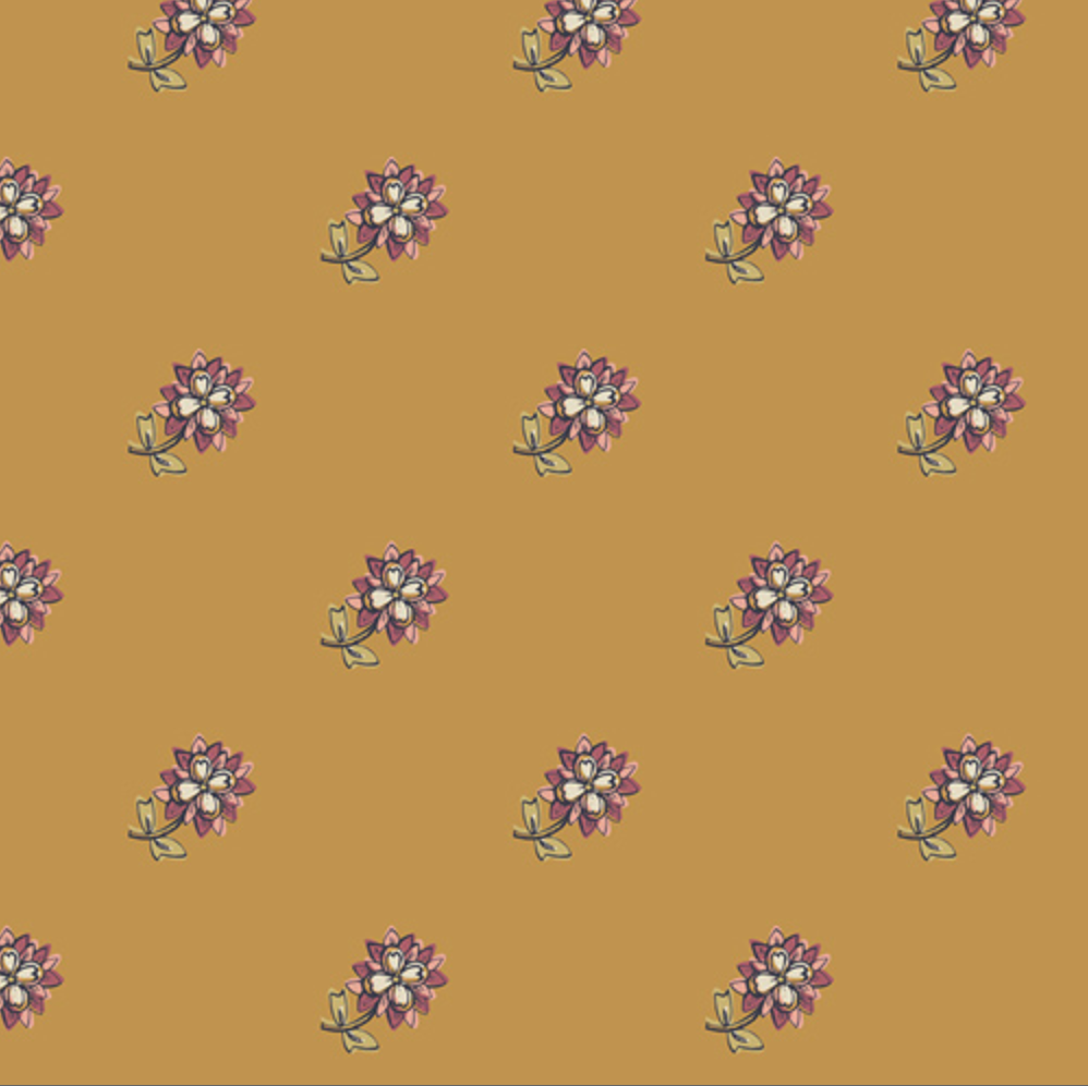 A repeating floral pattern on a warm mustard-yellow background, with small purple and white flowers and green stems. A ruler strip appears along the bottom edge for scale.
