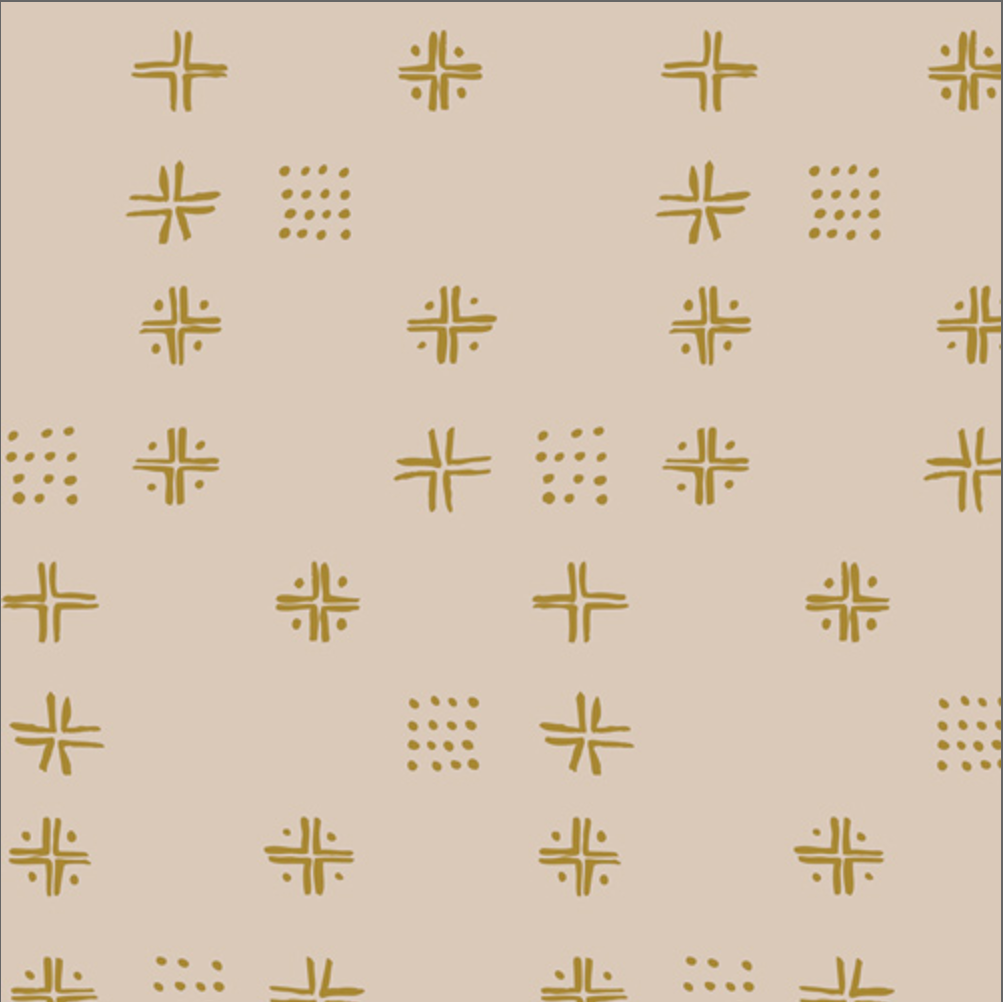 Beige fabric with a repeating pattern of mustard yellow geometric symbols, including crosses, stars, and dotted clusters, shown with a ruler at the bottom for scale.