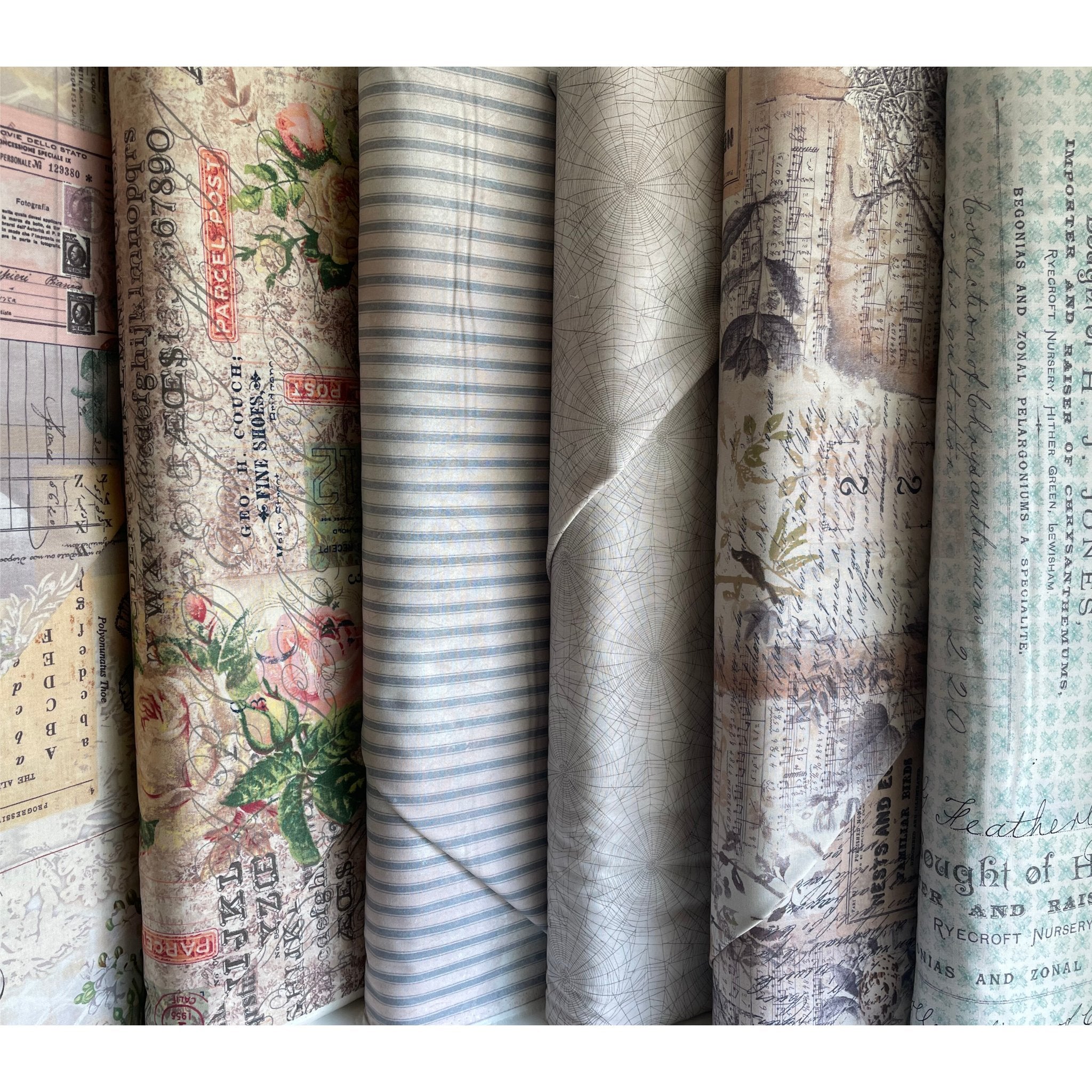 The image shows many different vintage-inspired fabric cuts overlapping on a flat surface.