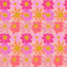 Pattern of pink and orange flowers with yellow centers on a light pink background