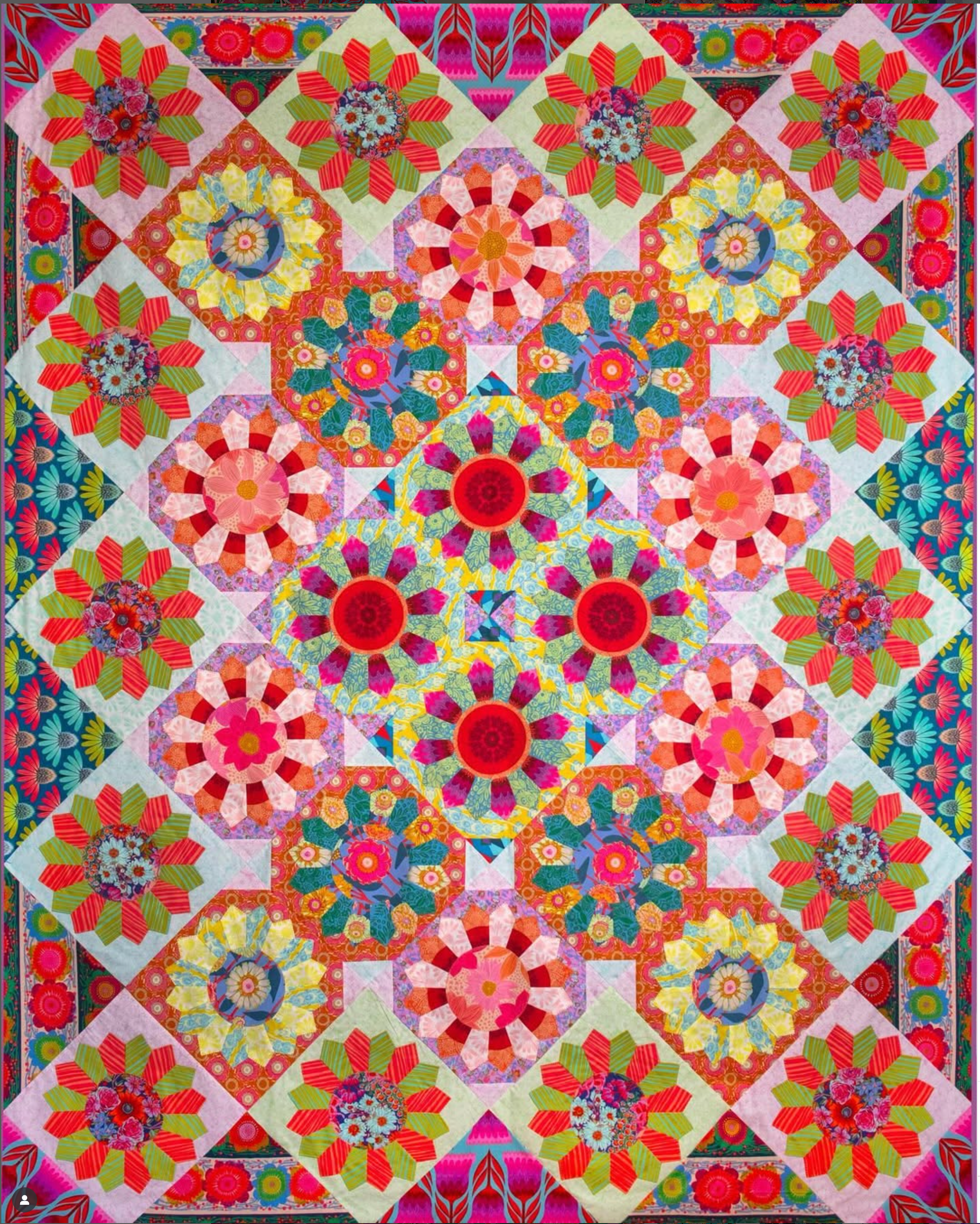 Colorful quilt with geometric floral patterns
