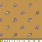 A repeating floral pattern on a warm mustard-yellow background, with small purple and white flowers and green stems. A ruler strip appears along the bottom edge for scale.