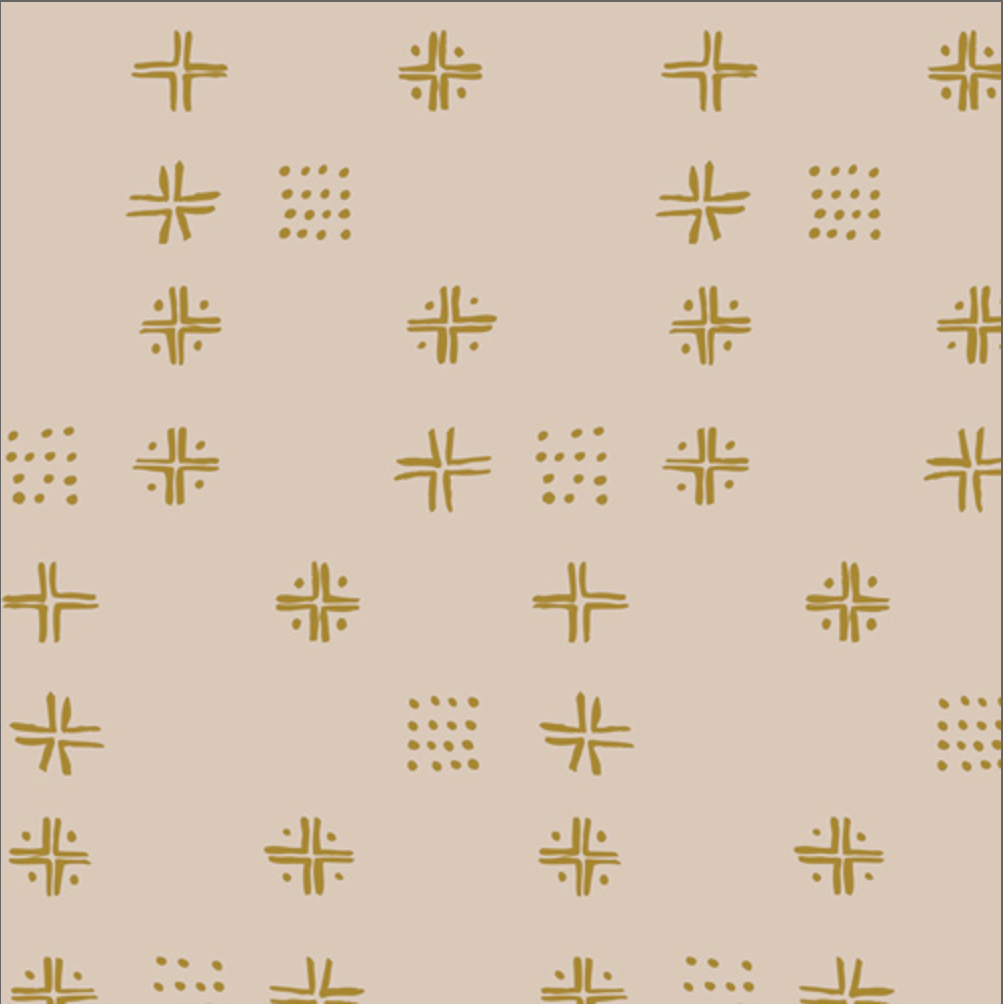 Beige fabric with a repeating pattern of mustard yellow geometric symbols, including crosses, stars, and dotted clusters, shown with a ruler at the bottom for scale.