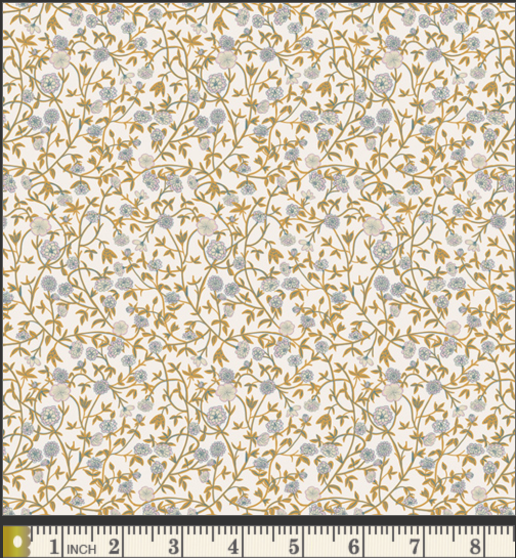 A close-up of a fabric 
pattern with a dense floral vine design in muted blue-gray and mustard-gold on a warm off-white background, with a measurement ruler along the bottom edge.