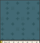 A close-up of a teal fabric pattern featuring repeating dark teal geometric motifs, with a cream-colored fabric ruler visible along the bottom edge for scale.