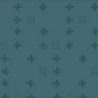 A close-up of a teal fabric pattern featuring repeating dark teal geometric motifs, with a cream-colored fabric ruler visible along the bottom edge for scale.