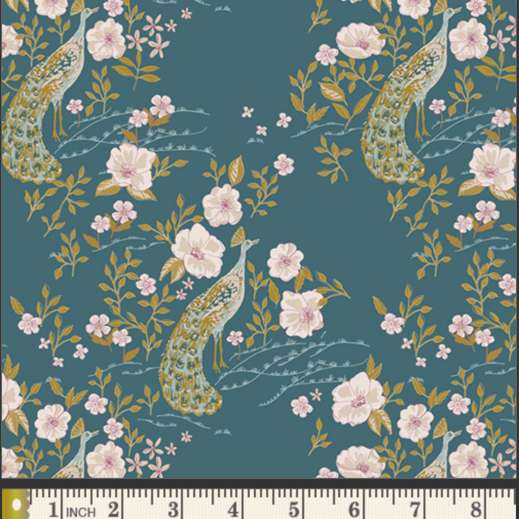 A repeating fabric pattern featuring peacocks, pink flowers, and green leaves on a dark teal background, with a ruler along the bottom edge showing measurement scale.