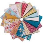 A circular fan arrangement of multiple fabric swatches with various floral and paisley patterns in pink, blue, teal, yellow, and red on a white background.