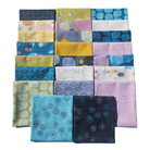 Collection of colorful fabric squares arranged in a grid pattern on a white background
