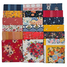 Stack of colorful fabric squares with floral patterns on a white background