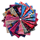 A collection of colorful patterned fabric squares arranged in a circular fan shape on a plain white background.