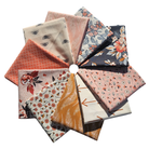 Collection of patterned fabric squares arranged in a circular fashion on a white background.