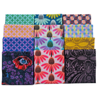A 3x4 grid of 12 folded fabrics showcasing a variety of colorful patterns including geometric, floral, and paisley designs in vibrant shades of pink, blue, green, yellow, and purple.