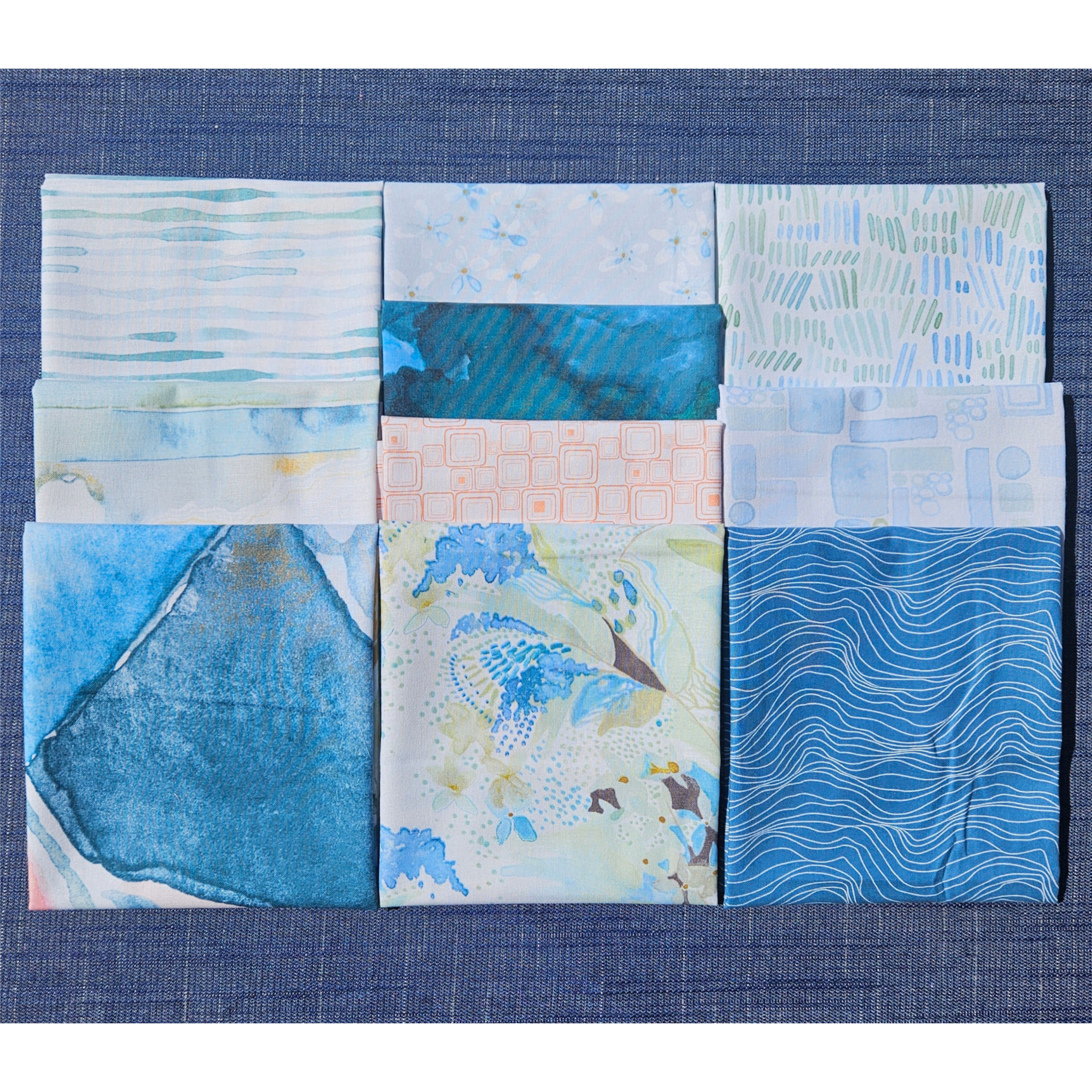 Set of fabric swatches with blue and green patterns on a blue background