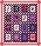 Quilt with colorful patchwork design featuring various patterns and colors.